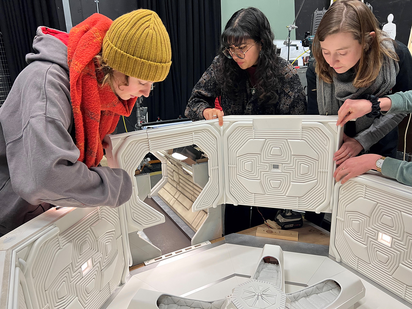 Students assembling the walls of the model
