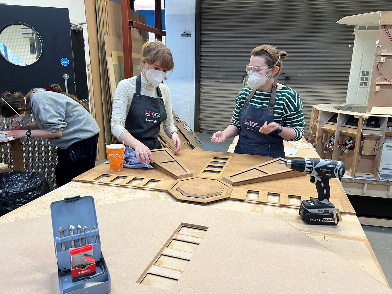 Model making students working on the ceiling piece, which was split in two for camera and lighting access.