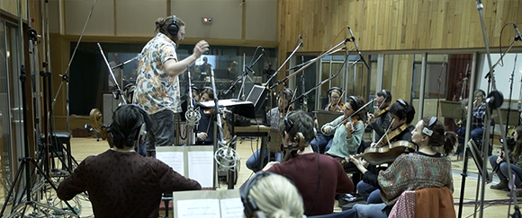 Pic of Ethan Jeffrey with orchestra