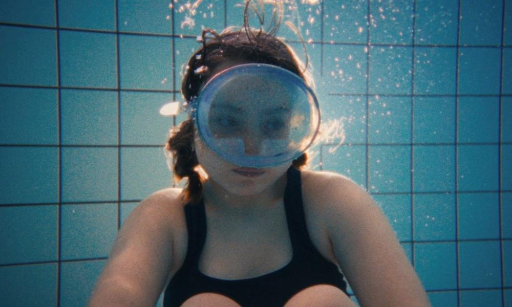 girl in pool with swim goggles on