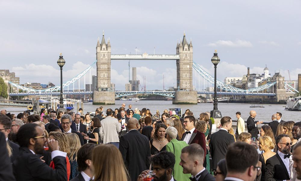 crowd of people with london bridge in background